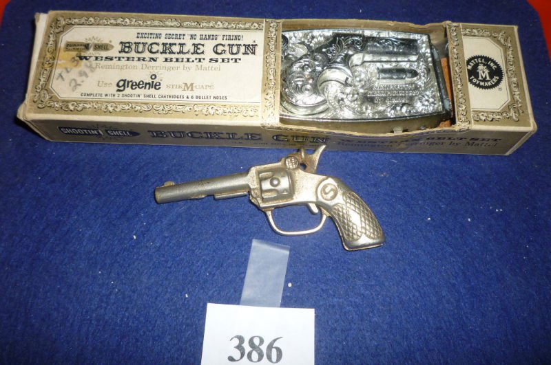 MATTEL SHOOTIN SHELL BUCKLE GUN AND SMALL METAL CAP: MATTEL BUCKLE GUN IN ORIGINAL BOX AND SMALL METAL CAP GUN: BUCKLE GUN MADE BY MATTEL 1958, REMINGTON DERRINGER. USES GREENIE STIK-M-CAPS. COMES COMPLETE WITH 2 SHOOTIN' SHELL CARTRIDGES AND 6 BULLET C