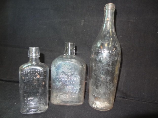 ANTIQUE GLASS BOTTLES: ONE MARKED "FULL QUART TELEGRAM: TELEGRAM WHISKEY DAVID NETTER & CO. FIFTH AND MARKET ST PHILLY". ONE MARKED "TAYLOR & WILLIAMS WHISKEY LOUISVILLE KY". LAST ONE MARKED "GUARANTEED 8 OZ FULL 1/2 PINT." ALL IN GOOD CONDITION
