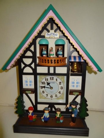 CUCKOO CLOCK: SMALL WORLD RHYTHM QUARTZ, DETAIL IN: IN SWISS MOTIF, musical, see additional pictures of back and pendulum