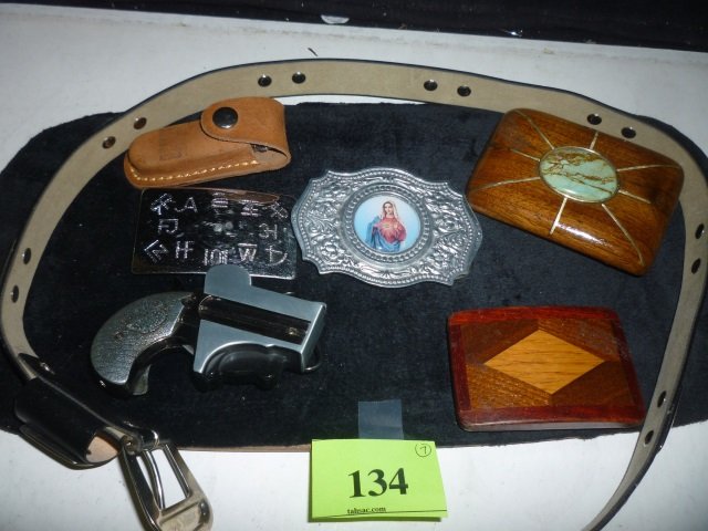 BELT BUCKLES: ONE RELIGIOUS, ONE WITH SYMBOLS, A GUN LI: SYMBOLS, A GUN LIGHTER, 2 OTHERS, A BOCKET KNIFE IN CASE, AND BELT