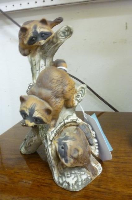 PORCELAIN RACOONS FIGURE PAINTED PORCELAIN FIGURE OF 3 : PAINTED PORCELAIN FIGURE OF 3 RACOONS CLIMBING ON A TREE TRUNK, STAMPED "MASTERPIECE PORCELAIN BY HOMCO" ARTIST SIGNATURE ON BOTTOM "MR" APPROX 8" TALL