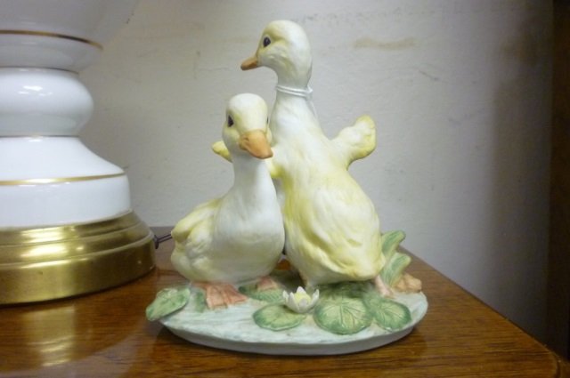 PORCELAIN DUCKLINGS FIGURE PAINTED PORCELAIN GIGURE OF : PAINTED PORCELAIN GIGURE OF 2 YELLOW DUCKLINGS IN LILLY PADS, STAMPED "MASTERPIECE PORCELAIN BY HOMCO" ARTIST SIGNATURE "MR", ALSO CARVED IN BOTTOM IS "HOMCO C 1982", APPROX 6" TALL