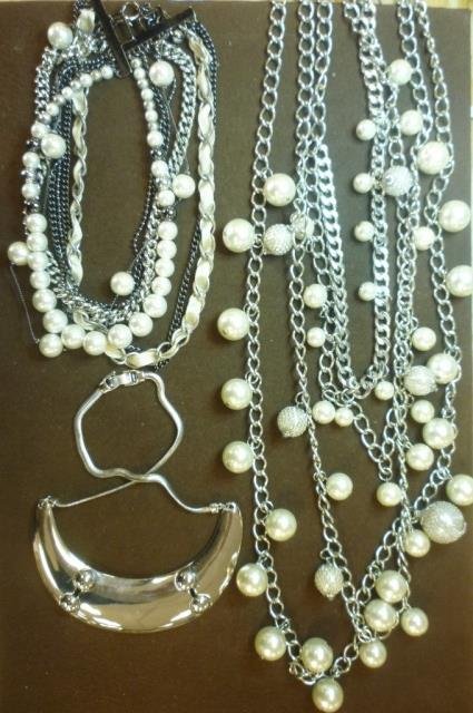 SILVER TONE NECKLACES THREE SILVER TONE FASHION: THREE SILVER TONE FASHION NECKLACES: ONE EXTRA LONG MULTI LAYER WITH LARGE FAUX PEARLS, ONE MIXED 7 STRAND SILVER TONES, FAUX PEARLS AND RIBBON, ONE SHORT SILVER TONE HALF MOON BRANDED NINEWEST.