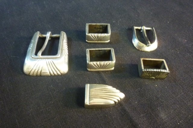 4 BELT ACCESSORIES 4 ITEM LOT COMPRISED OF SILVER TONE: 4 ITEM LOT COMPRISED OF SILVER TONE BELT BUCKLE, BELT TIP AND TWO PEICES WHICH THE SIDES OF THE BELT WILL GO INTO, MARKED "TAIWAN"