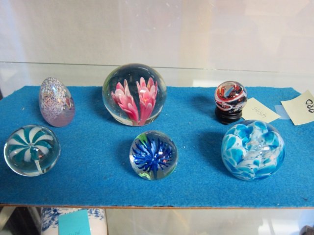 SIX HAND BLOWN GLASS PAPER WEIGHTS LOT OF (6) HAND: LOT OF (6) HAND BLOWN GLASS PAPER WEIGHTS. ONE WITH STAND AND ONE EGG SHAPED.