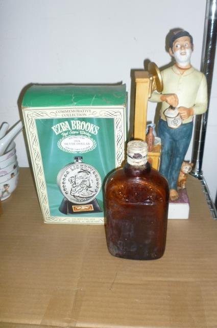 WHISKEY COLLECTIBLES 1/2 SHELF LOT INCLUDES OLD BROWN: 1/2 SHELF LOT INCLUDES OLD BROWN GLASS WHISKEY BOTTLE, COMMEMORATIVE SILVER DOLLAR WHISKEY BOTTLE AND FIGURINE