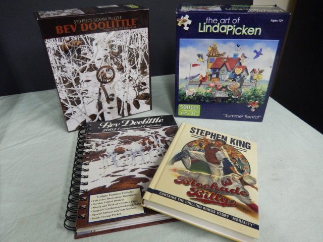 PUZZLES, BOOK, CALENDAR LOT INCLUDES TWO PUZZLES, ONE: LOT INCLUDES TWO PUZZLES, ONE FEATURING BEV DOOLITTLE, ONE BEV DOOLITTLE ENGAGEMENT CALENDAR AND ONE HANDBACK COPY OF "BLOCKADE BILLY" BY STEPHEN KING