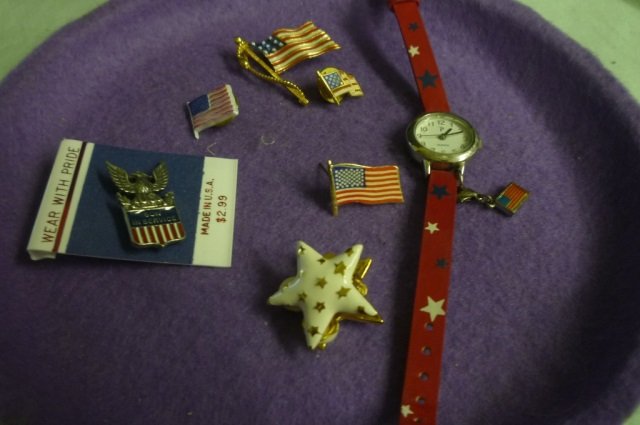 FLAG JEWELRY LOT INCLUDES 4 AMERICAN FLAG PINS, 1 "SON: LOT INCLUDES 4 AMERICAN FLAG PINS, 1 "SON IN SERVICE" PIN, 1 PAIR OF FLAG CLIP ON EARRINGS AND 1 STAR WATCH WITH CHARM.