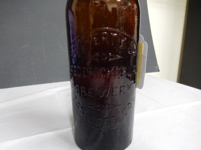 ANTIQUE FREDERICKSBURG BREWERY BOTTLE ANTIQUE AMBER: ANTIQUE AMBER BEER BOTTLE MONGRAMMED "PROPERTY OF THE FREDERICKSBURG BREWEY, SAN JOSE, CAL." APPROX 11.25' TALL. SMALL NICK IN GLASS ON TOP (SEE PIC) OTHERWISE IN EXCELLENT CONDITION.