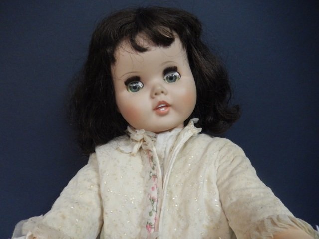 VINTAGE DOLL VINTAGE DOLL WITH GREEN BLINKING EYES,: VINTAGE DOLL WITH GREEN BLINKING EYES, MOVING ARMS AND LEGS WITH ORIGINAL HAIR. MADE BY THE AMERICAN TOY COMPANY. CIRCA 1960. APPROX 24' TALL