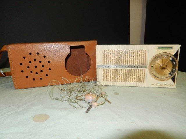 VINTAGE PORTABLE RADIO VINTAGE PORTABLE RADIO BY: VINTAGE PORTABLE RADIO BY GENERAL ELECTRIC. COMES WITH LEATHER TRAVEL CASE AND EAR BUDS