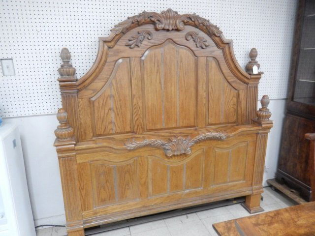 QUEEN SIZE BED FRAME ORNATE CARVED WOOD QUEEN SIZE BED: ORNATE CARVED WOOD QUEEN SIZE BED FRAME WITH RAILS. HEADBOARD IS APPROX 68" TALL AT PEAK. FOOTBOARD IS APPROX 33" TALL