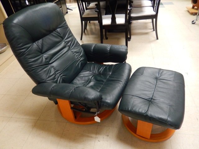 GREEN LEATHER RECLINER: COMES WITH FOOTSTOOL. CHAIR IS STATIONARY AND DOES NOT ROCK OR SWIVEL. LEATHER IS IN GOOD CONDITION WITH NO RIPS OR TEARS IN FABRIC