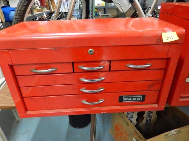 PARK TOOL BOX: RED WITH LID AND 6 DRAWERS. LID AREA IS FILLED WITH SOCKETS. APPROX 26.5" X 15" X 12.5"