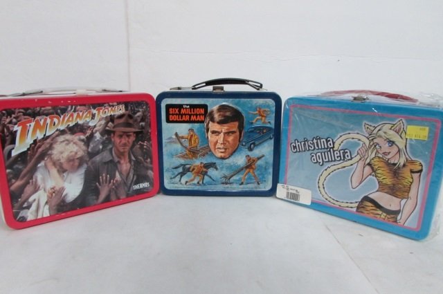 3 STEEL LUNCH BOXES: 1974 THE SIX MILLION DOLLAR MAN, INDIANA JONES, & CHRISTINA AGUILERA (NEW)