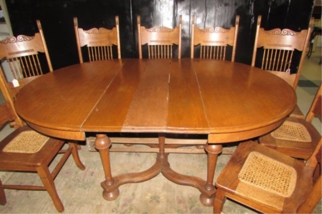 OAK TABLE AND CHAIRS 8 SPINDEL BACK CHAIRS WITH CANED: 8 SPINDEL BACK CHAIRS WITH CANED SEATS, THREE 8" LEAVES, ONE CHAIR NEEDS RECANING, 71" LONG INCLUDING 3 LEAVES
