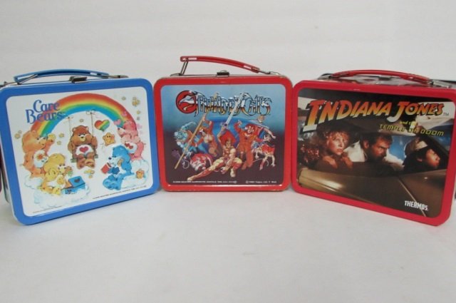 3 VINTAGE STEEL LUNCH BOXES 1985 THUNDERCATS (THERMOS: 1985 THUNDERCATS (THERMOS INCLUDED, SLIGHTLY RUSTY INSIDE), 1984 INDIANA JONES (THERMOS INCLUDED), & CARE BEARS (THERMOS INCLUDED)