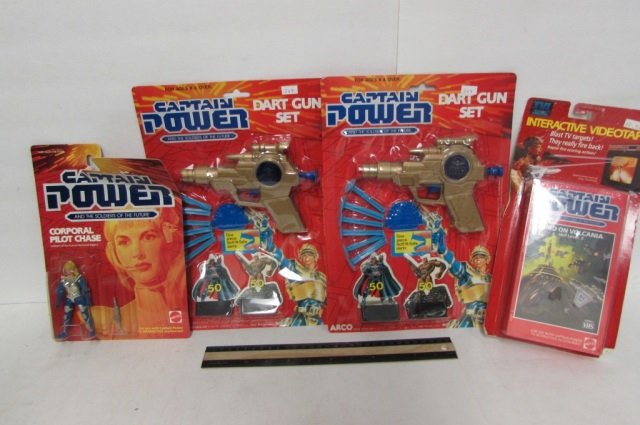 4 CAPTAIN POWER ITEMS CAPTAIN POWER RAID ON VOLCANIA: CAPTAIN POWER RAID ON VOLCANIA (FOR THE USE WITH CAPTAIN POWER TV INTERACTION ACCESSORIES), CORPORAL PILOT CHASE FIGURE, & (2) DART GUN SETS