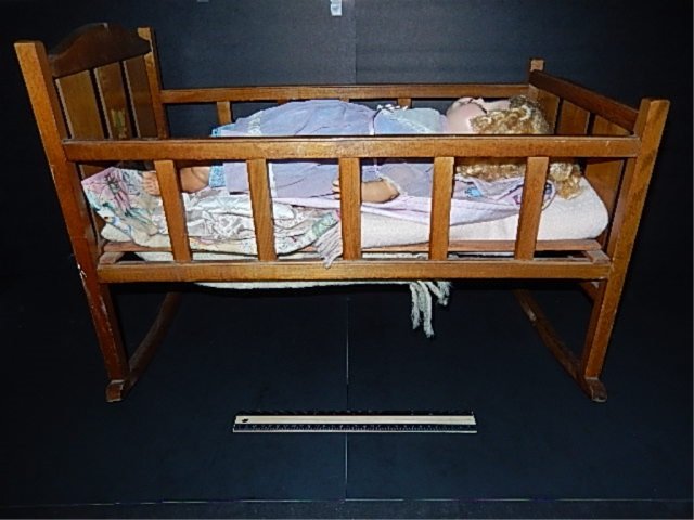 VINTAGE DOLLS CRADLE AND DOLL WOOD DOLLS CRADLE GOOD: WOOD DOLLS CRADLE GOOD CONDITION SOME BEDDING INCLUDED ALSO VINTAGE DOLL IN FAIR CONDITION