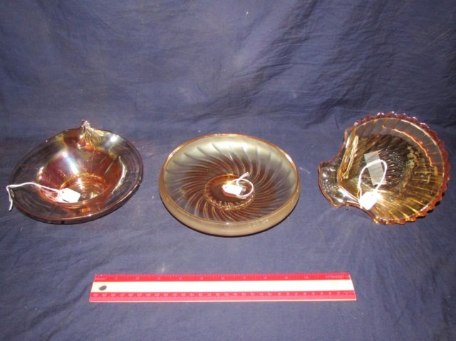 VINTAGE CARNIVAL GLASS DISHES (3) THREE VINTAGE: THREE VINTAGE CARNIVAL GLASS DISHES, RIDGED SOAP DISH IN THE SHAPE OF A SEASHELL HAS A SMALL CHIP ON RIM AND MEASURES ABOUT 7 INCHES ACROSS, GLASS BOWL HAS FOUR SEAMS WITH AN EMBOSSED FLORAL DESIGN (C