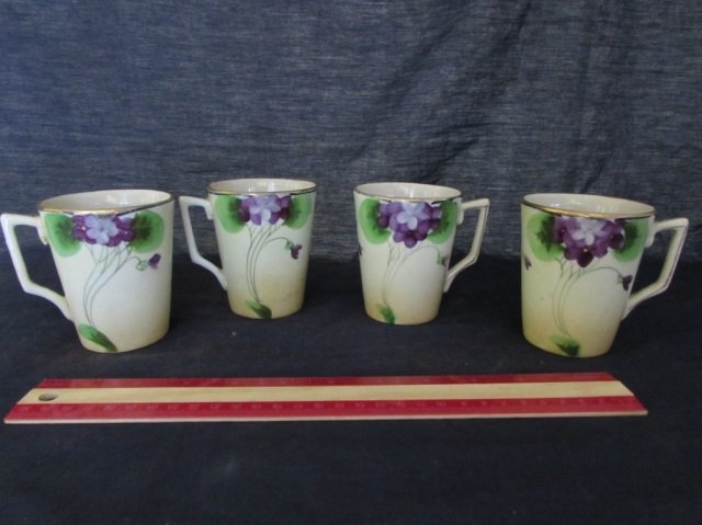 JE-OH NIPPON HAND-PAINTED FLORAL CUPS (4) FOUR NIPPON: FOUR NIPPON HANDLED CUPS WITH FLORAL DESIGN ARE MARKED JE-OH CHINA HAND-PAINTED NIPPON, ALL MEASURE 3.75 INCHES TALL BY 3 INCHES WIDE, ALL IN GOOD CONDITION.