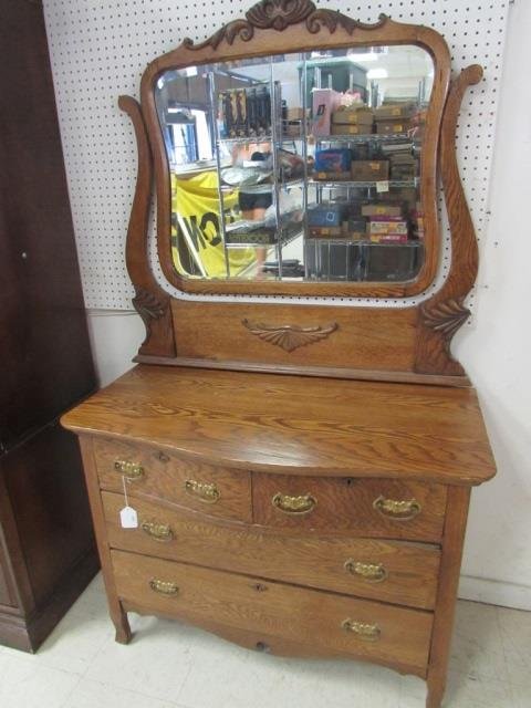VINTAGE OAK VANITY DRESSER WITH MIRROR OAK VANITY: OAK VANITY DRESSER WITH MIRROR HAS SWIVEL MIRROR AND CARVINGS, STANDS ON FEET, FOUR LOCKABLE PULL-OUT DRAWERS WITH BRASS DRAWER PULLS, MEASUREMENTS ARE 72 INCHES TALL WITH MIRROR (32 INCHES WITHOUT MI