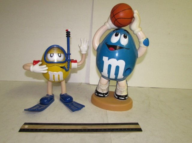 PLASTIC M&M CANDY DISPENSERS (2): PLASTIC M&M CANDY DISPENSERS (2) ONE BASKETBALL THEME & ONE SCUBA THEME, BOTH ARE IN GOOD CONDITION