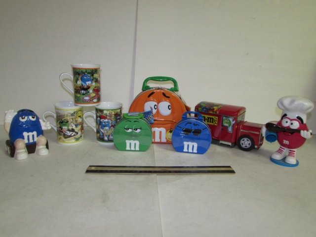 9 M&M NOVELTY ITEMS: 9 M&M NOVELTY ITEMS (3) M&M MUGS, LUNCH BOX, TIN CANDY JAR, & CANDY DISPENSERS