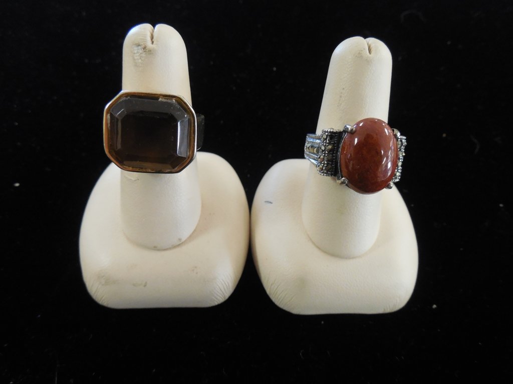 WOMAN'S FASHION RINGS (2): WOMAN'S FASHION RINGS (2) MONET GLASS STONE RING AND A MARCASITE SETTING 925 RING WITH NATURAL STONE.