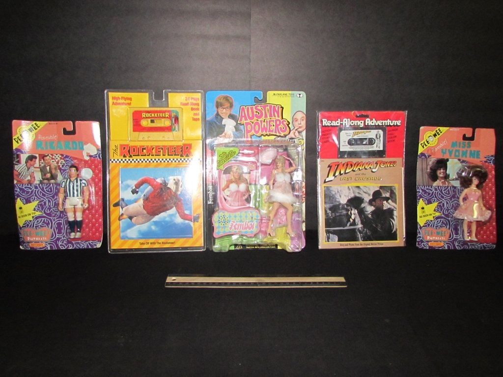 COLLECTIBLE ACTION FIGURES AND READ-ALONG BOOKS: ALL ARE IN ORIGINAL PACKAGING, (2) PEE WEE'S PLAYHOUSE RICARDO & MISS YVONNE FIGURES, INDIANA JONES READ ALONG ADVENTURE BOOK AND TAPE, THE ROCKETEER STORY BOOK AND TAPE, & AUSTIN POWERS FEMOT FIGURE