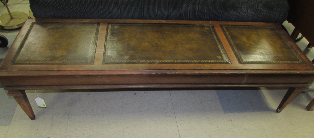 LEATHER INLAY COFFEE TABLE: LEATHER INLAY COFFEE TABLE MAHOGANY TABLE WITH THREE LEATHER INLAY PARTS, MEASURES 60" WIDE X 14" TALL X 19.5" DEEP. SHOWS WEAR.