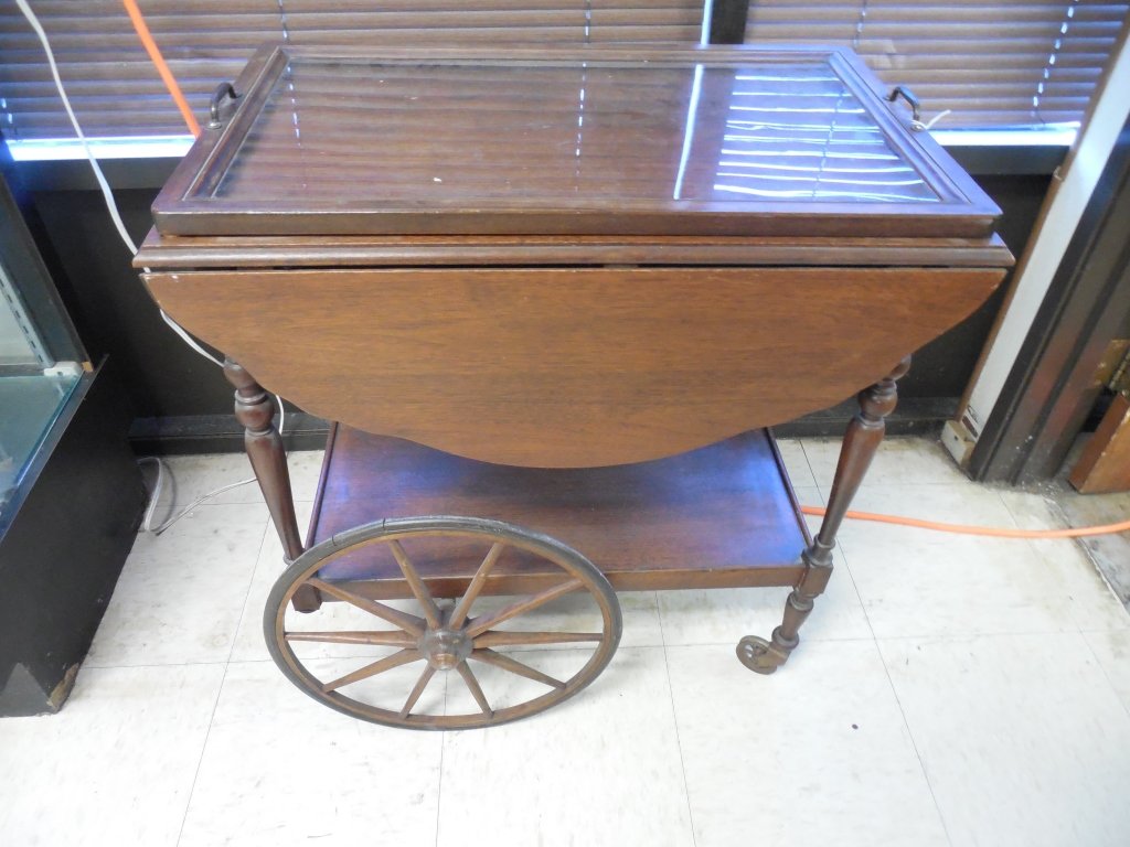 VINTAGE TEA CART: VINTAGE TEA CART MAHOGANY WOOD TEA CART WITH TWO LARGE WHEELS AND 2 SMALL FRONT WHEELS. REMOVEABLE GLASS TRAY. 28" TALL BY 26" LONG. TWO DROP LEAF EXTENSIONS . 36" WIDE WITH EXTENSIONS UP