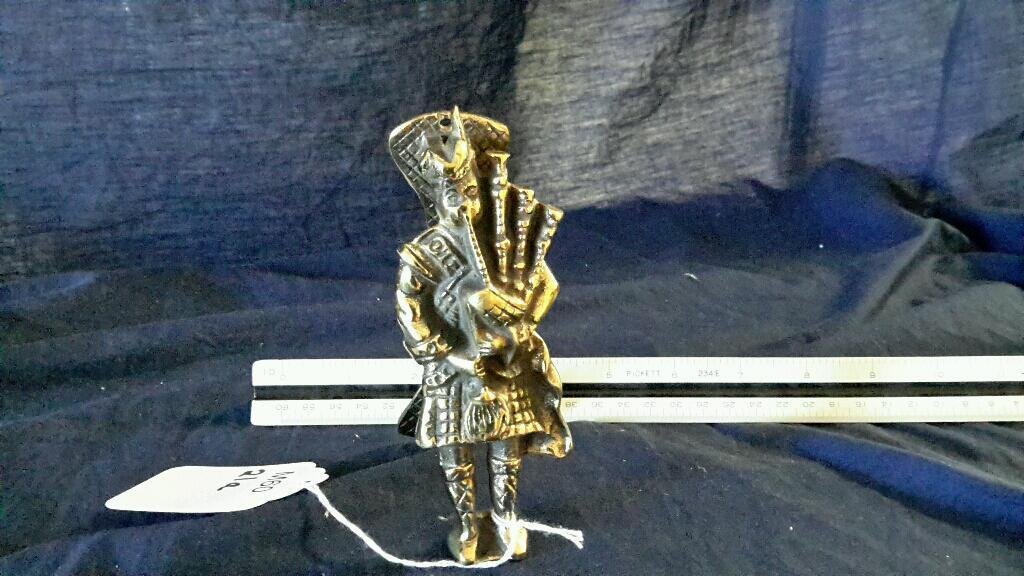 brass door knocker shaped as a Scottsman: brass door knocker in the shape of a Scotts man with bagpipes