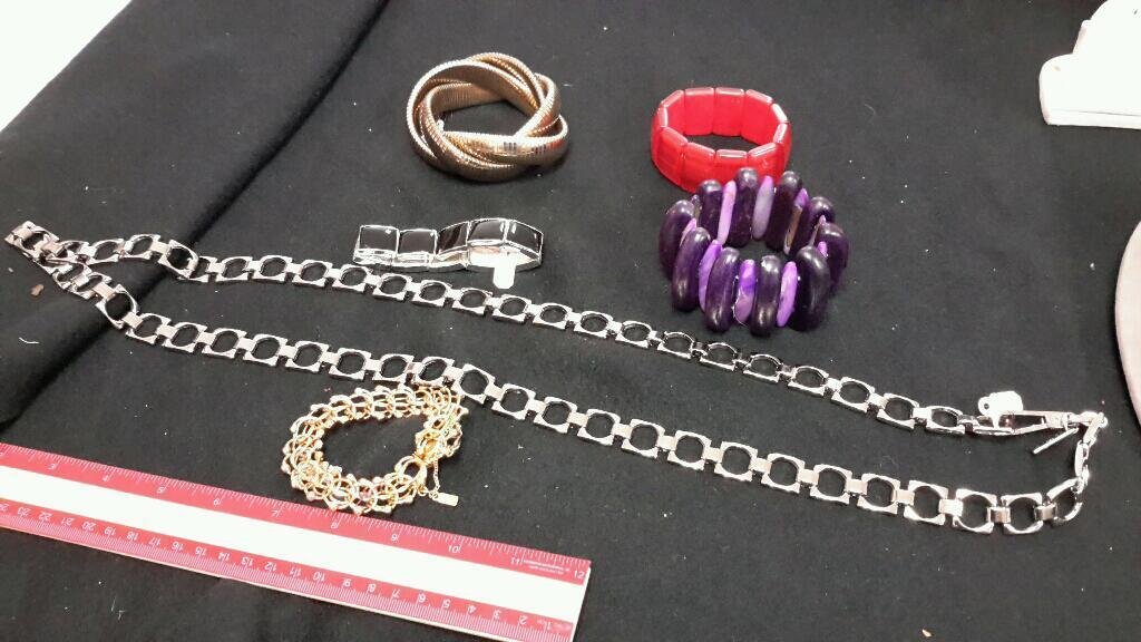 Costume Jewelry (6): Calvin Klein Silver tone chain belt, 3 stretch bracelets, monet gold bracelet, and one other gold tone bracelet. 