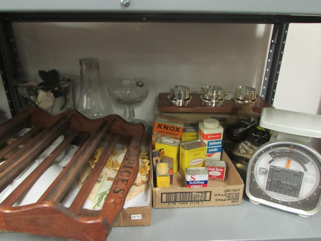Spices, Oil Lamp, and Kitchenware: Vintage spice cans, USPS weight scale, decanter, clear glass oil lamp, cups and saucers, and more.