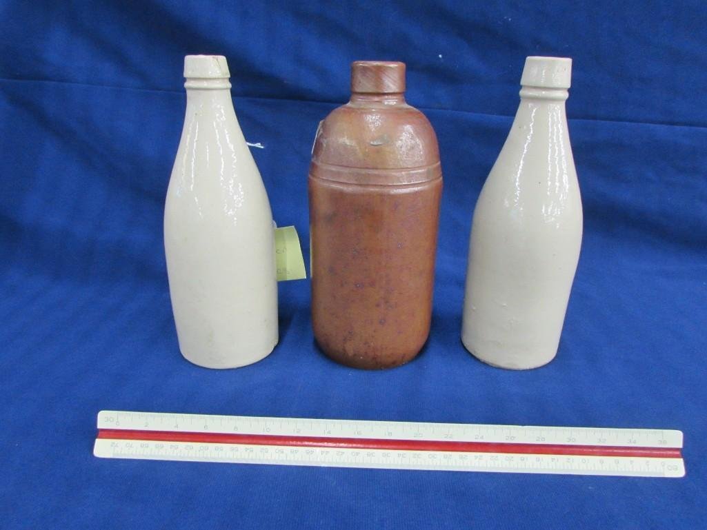 Vintage pottery bottles (3): One brown bottles has no marks and measures 8.5", & (2) cream colored bottles are marked but unreadable, 8.5" tall