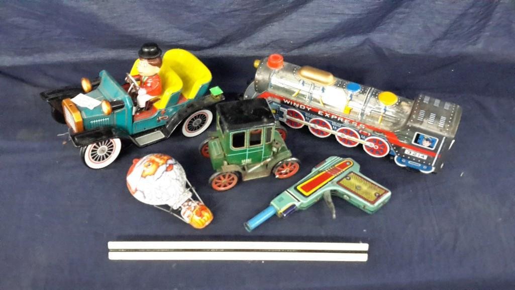 Vintage Metal Tin Toys (5): 5 Sets of vintage metal tin toys. 1. Loco motive train. Measures 4" height & 13" long. 2. Vintage car w/man. Measures 6' height by 12" length. Both battery operated. Plus 2 more.