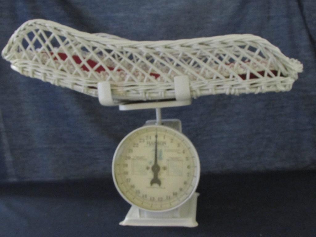 Vintage Baby Scale with Wicker Basket: Hanson white metal Nursery Scale (15" tall x 23" wide), comes with white Wicker basket and a red cushion. Scale is in good condition.