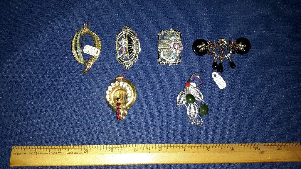 Collection of Vintage Brooches (6): Nice collection of Vintage Brooches. Includes a Black, Garnet, and Marcasite detailed brooch, a Marcasite floral design and jeweled brooch and more. All are in good condition.