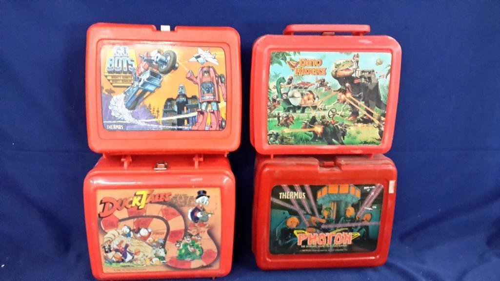 Vintage Plastic Lunch Boxes (4): Assortment of plastic lunch boxes including, 1984 Go Bots, 1987 Photon with Thermos, 1986 Ducktails with Thermos and 1988 Dinoriders.