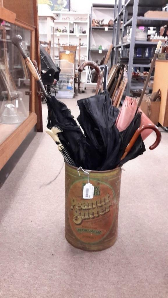Sterling and Wood Handle Umbrella Collection (7): Two have sterling silver handles, one in working condition with sterling band around engraved bamboo handle, 7 umbrellas all together. Peanut Butter can is included.
