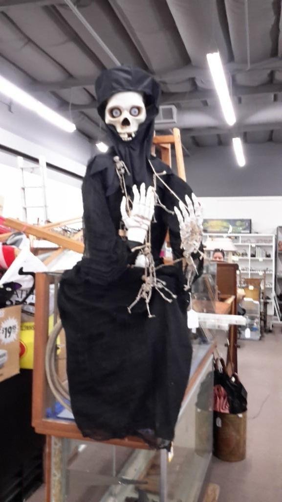 Skeleton Halloween Decoration: Sitting skeleton, no legs. Measures 53" from bottom of clothes to top of head and table top to top of head is 30". Neck needs repair.
