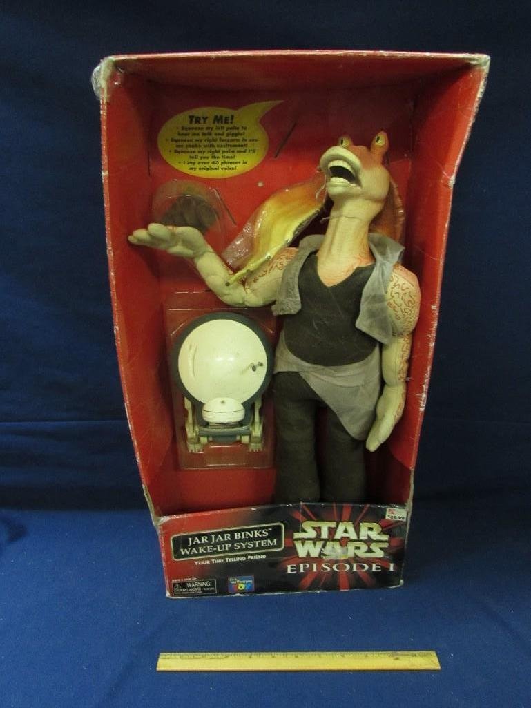 Star Wars Episode 1 Jar Jar Binks Wake-Up System: In box, box not in good condition. Comes with a Pit Droid time piece. Soft and cuddly Jar Jar Binks. Gentle waking shaking motion. Measures 23" tall, 12" wide and 5 1/2" deep. 