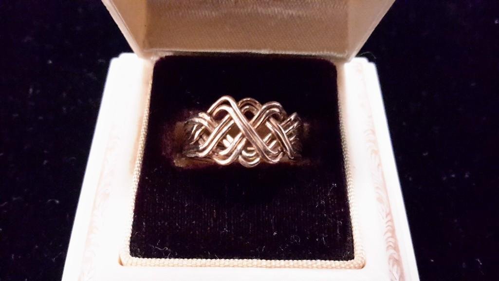 Ladies Yellow Gold Puzzle Ring: Light weight wire ring, with total of 8 rings soldered together, size 5.5