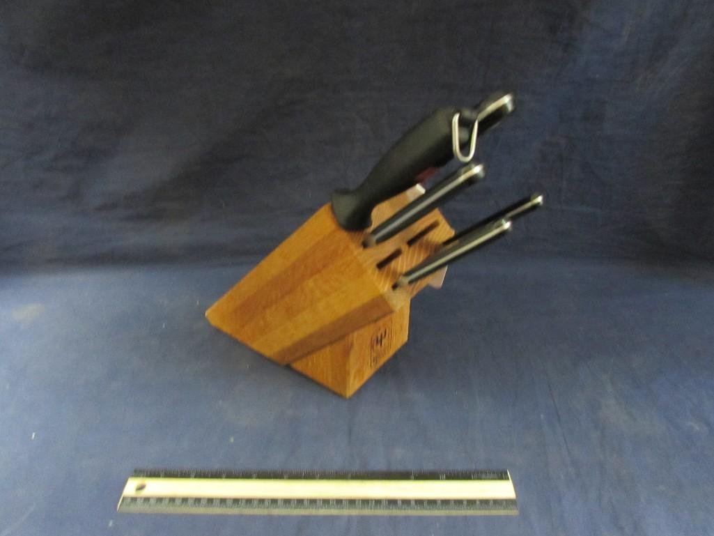 Wusthof Trident Knife Block with Knives: 4 knives and sharpener. Measures 11 1/2" tall with knives inside. Base is 8" deep. Incomplete set. 