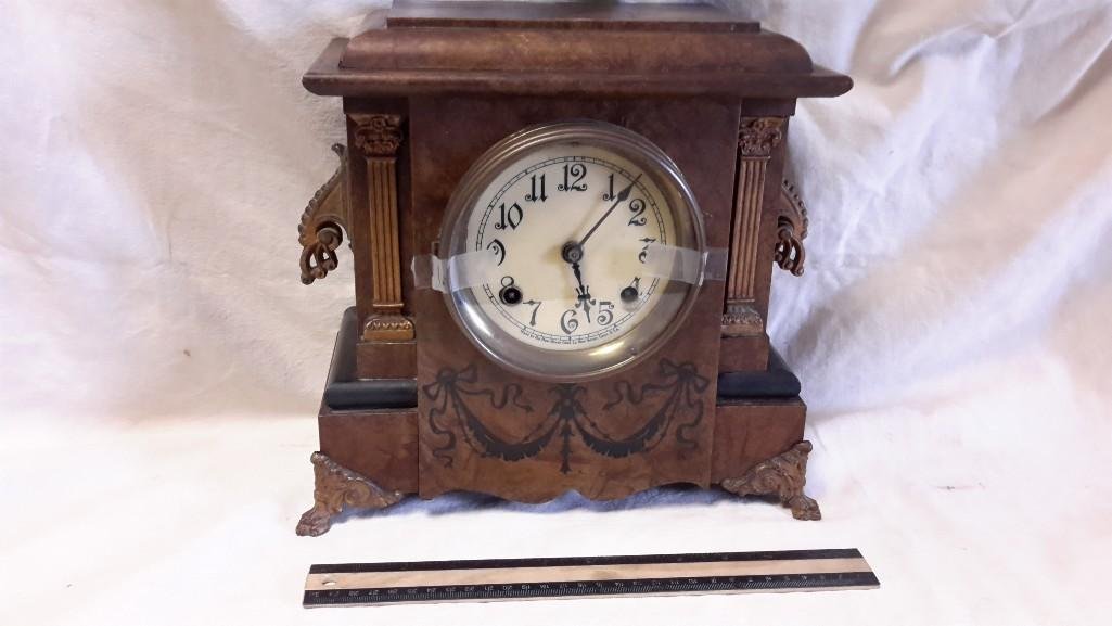Seth Thomas Mantle Clock: Hinge broken to glass front, key included. Measures 11 1/2" tall and 11 1/2" wide, 6" deep. Metal feet. Back stamped Seth Thomas. Face says Made by New Haven Clock Company, New Haven, C