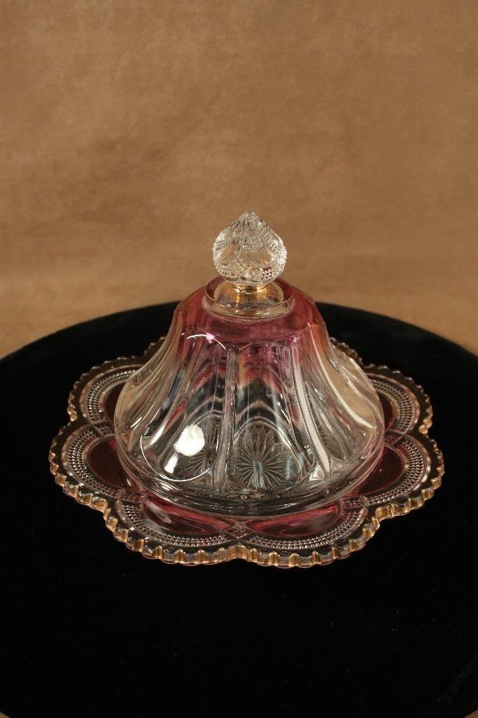 Clear and Cranberry Cut Glass Candy Dishes (2): Round dish with lid stands 6 1/2" tall and has small chip on top of lid. Lower dish has gold detail, with lid and measures 7" tall, little wear on gold. 