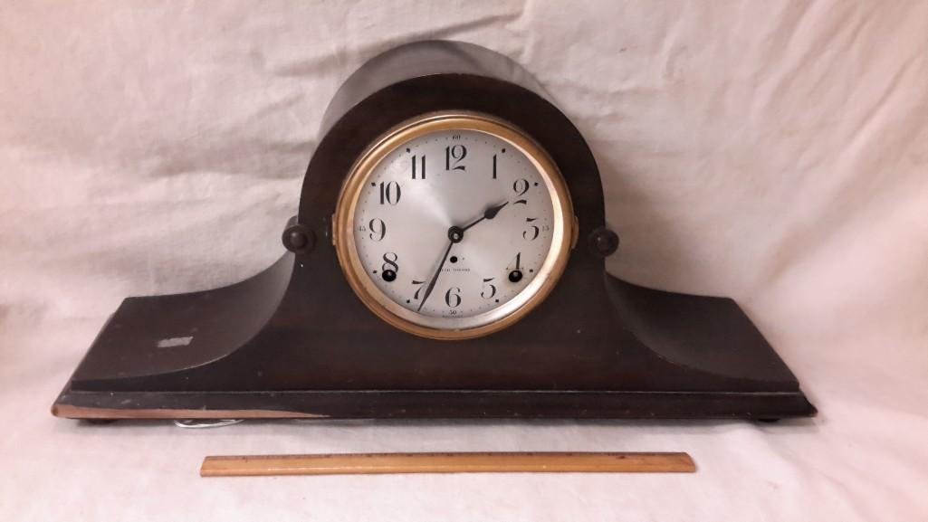 Seth Thomas Mantle Clock: Made in the USA, metal face, measures 9.5" tall, 20" wide, 5.5" deep, glass is missing from door that covers face, 7" break in the wood of the base