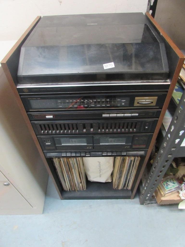 GE Compacgt Stereo Sound System and Records: AM/FM Radio, Cassette tapes, high speed dubbing, record player on top. Vinyl albums and bag of cassette tapes also included. Has not been tested. 