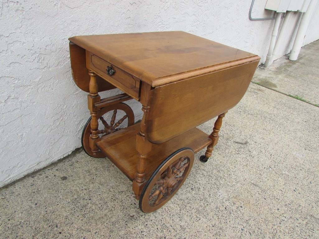 Maple Tea Cart: Drop leaf side, one drawer, one shelf, two large wheel, two small casters, glass shelf missing, good condition, measures 29" tall